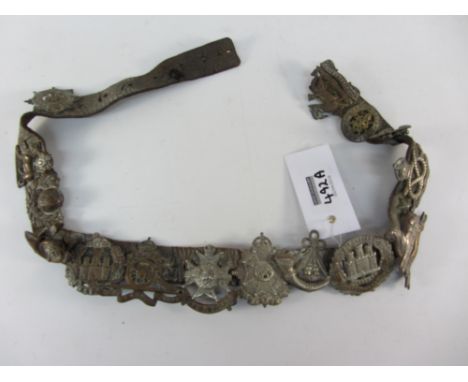 Leather Army belt with 15 badges and a booklet 'Rank and Badges in the Navy Army and RAF'