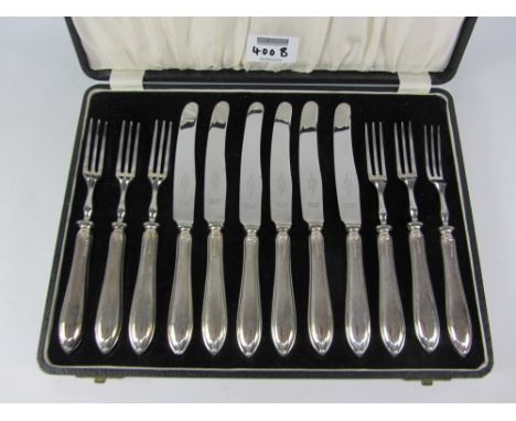 Cased set of knives and forks with hallmarked silver handles