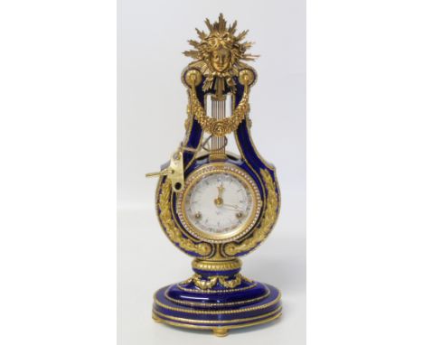 A ceramic and gilt metal mantle clock with sunburst mount and jewelled bevel Condition reports are not available for this sal