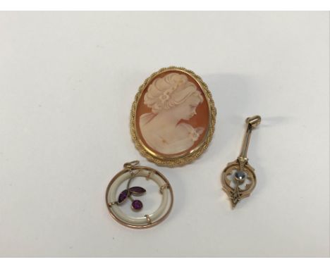 A 9ct gold mounted opal Cameo brooch, a 9ct gold Edwardian drop pendant and a circular pendant