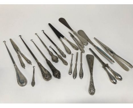 A collection of silver handled shoe horns, glove stretchers, button hooks etc