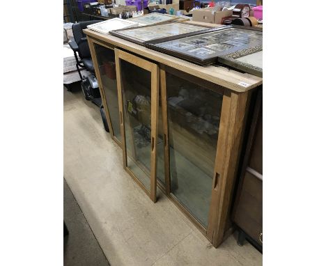 A pair of light oak three door display cabinets, with glass shelves (suitable for Antique centres and Shops), 154cm x 106cm x
