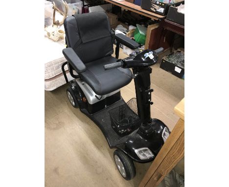 A Foru disability scooter with key, charger etc