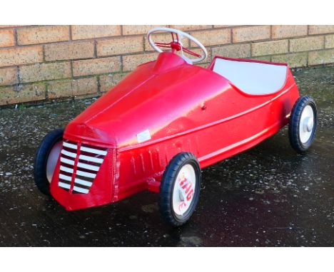 Eureka - A Eureka (France) pedal car in red. The car measures approximately 100cm (L) x 32cm (W) x 47 and shows signs of age 