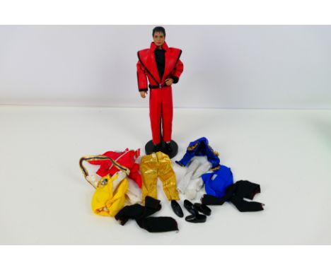 LJN Toys - An unboxed 1984 dated Michael Jackson figure on stand with some other clothes and shoes. He appears in Very Good o