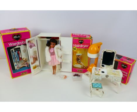 Sindy - Sindy doll and three boxed furniture pieces. Vintage brunette Sindy (0330ddx) wears a pink dress with white faux fur 