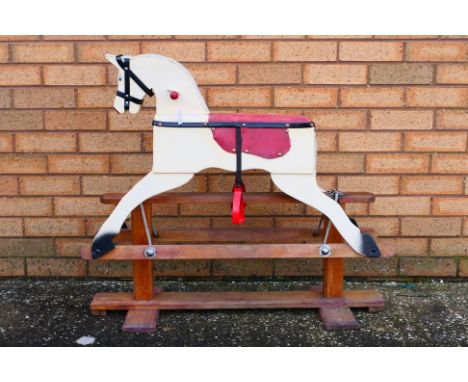 A small unmarked wooden rocking horse. The horse measures approximately 93 cms(L) x 36cms (W) x 80cms (H), and appears to be 