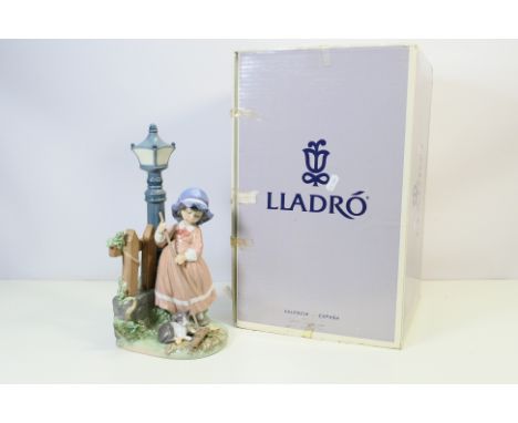 Lladro - a large figurine entitled 'Fall Clean-Up', model number 05286, portrays a young girl sweeping leaves near a street l
