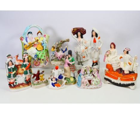 A collection of Staffordshire and continental figures / groups comprising a figure depicting a Scottish soldier and lady, the