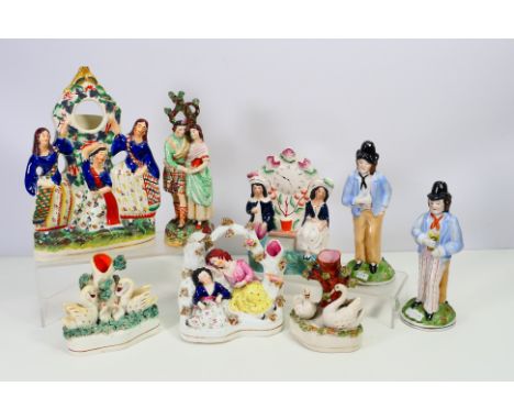 A collection of Staffordshire figures / groups to include two twin sided temperance figures, Gin and Water, approximately 22 