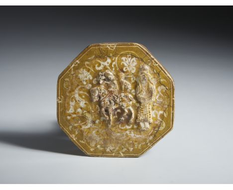 Octagonal tile with figurative decoration in reliefIran, 13th-14th century  Frit body, moulded with a figure of a knight and 