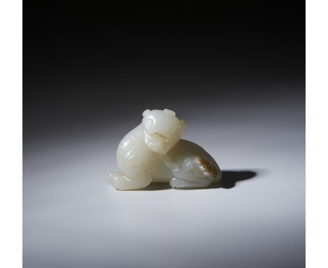 A fine carving in pale green with brown area jade, depicting a recumbent lionChina, Qing, 18th century Cm 5,00 x 4,00