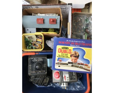 A Box containing a collection model Railway Track.Buildings.vehicles.transformers etc.