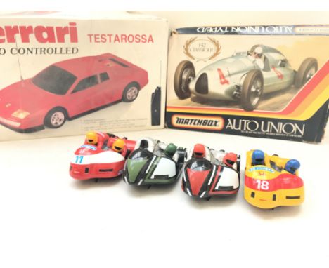 A Radio Controlled Ferrari. A Matchbox Auto Union Model kit and 3 Scalextric motorbike and Sidecars.