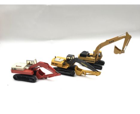 A collection of model construction vehicles. Boxed. Conrad Crawler Excavator # 2814 Poclain hydraulic Excavator 90 ck Cat E30
