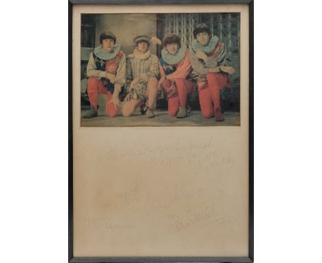 The Beatles. A framed signed photograph of the Beatles in Tudor style costume:, signed by George Harrison, John Lennon, Ringo