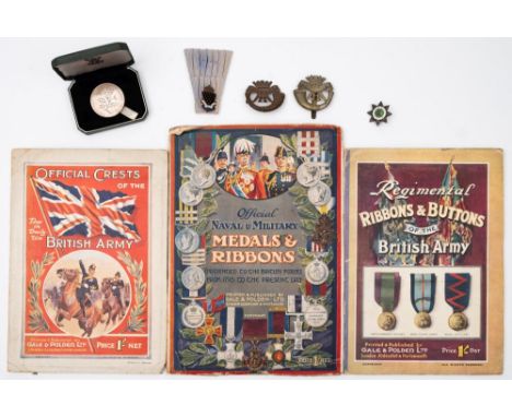 Two Cornwall Light Infantry cap badges:, together with two other enamel badges and three early 20th century wall charts of mi