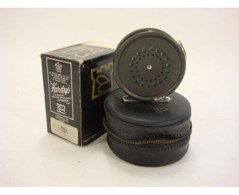 A Hardy Perfect 3 3/8 inch fly reel:, black handle, agate line guide and engine turned tensioner, in original case and box. 