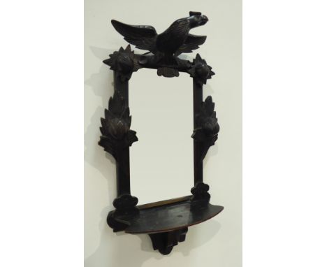 Late 19th century wall mirror with shelf, ebonised frame carved with bird, flower heads and foliage, 79cm x 44cm Condition Re