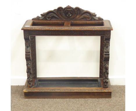 Victorian carved oak stick umbrella stand, raised shaped back carved with scrolled acanthus leaves and mask, with metal tray,