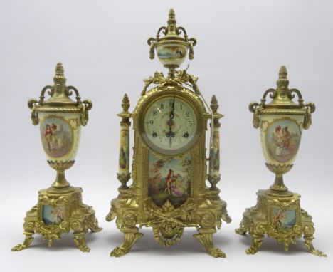 French gilt metal clock with garniture, urn finial above circular Arabic dial, twin train movement with floating balance esca