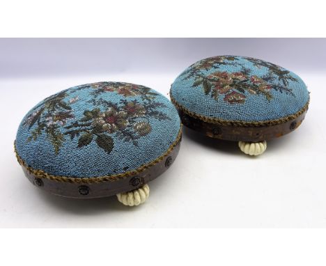 Pair Victorian circular bead work footstools, decorated with floral sprays, the frame having applied brass roundels on three 