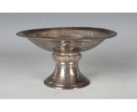 A George V silver bonbon tazza, the shallow hammered circular bowl engraved with fruiting vines, the underside engraved with 