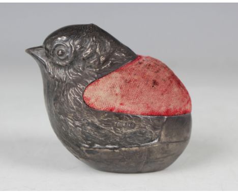 A George V silver novelty pin cushion in the form of a chick emerging from a cracked shell, London 1924 by Sampson Mordan &am