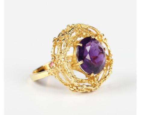 A gold and amethyst single stone ring, cast and pierced in a rustic design, detailed '750', weight 9.8g, ring size approx Q.B