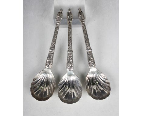A set of three late 19th/early 20th century Chinese silver serving spoons, each with foliate engraved scallop bowl, the taper