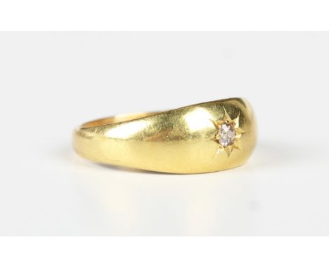 An 18ct gold and diamond single stone ring, star gypsy set with a cushion cut diamond, Birmingham 1919, weight 5.1g, ring siz