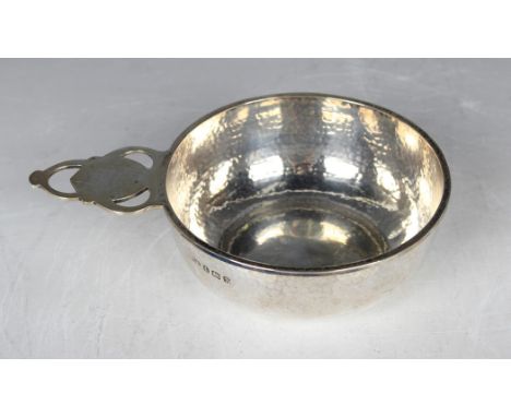 A George V silver circular bowl with hammered decoration and pierced tab handle, Birmingham 1923 by A.E. Jones, weight 111g, 