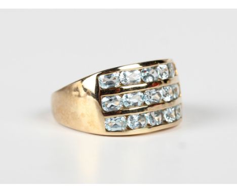 A 9ct gold ring, mounted with three rows of five oval cut pale blue topaz, Birmingham 2000, weight 5.4g, ring size approx S1/