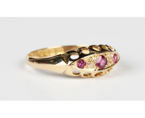 An 18ct gold, ruby and diamond ring, mounted with three rubies alternating with two pairs of rose cut diamonds in a boat shap