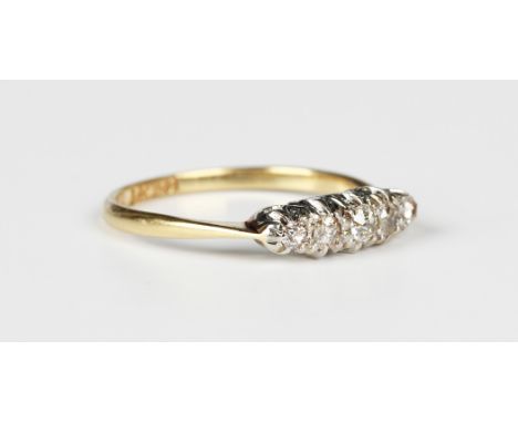 A gold, platinum and diamond five stone ring, mounted with a row of cushion cut diamonds graduating in size to the centre sto