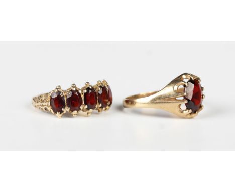 A 9ct gold and garnet five stone ring, mounted with a row of oval cut garnets, London 1973, ring size approx M, and a 9ct gol