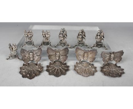 A set of four Chinese silver menu holders, each in the form of a butterfly on a stylized leaf base, height 3.5cm, and a set o