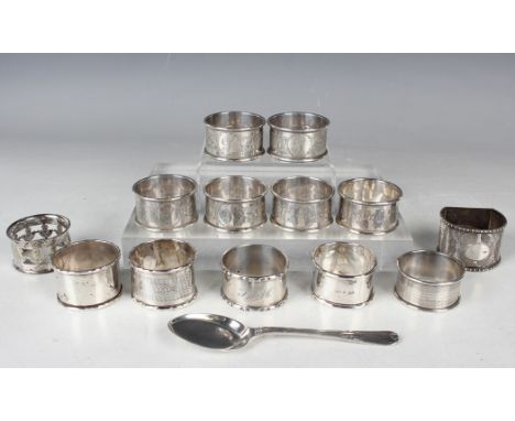 A set of six George V silver napkin rings, each with engraved foliate decoration, Birmingham 1923 by W.H. Haseler, five other