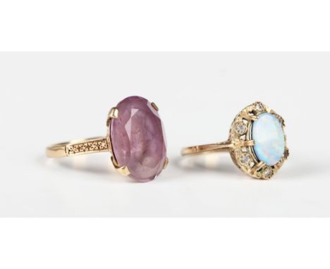 A gold ring, claw set with an oval cut amethyst, detailed '9ct', ring size approx O, and a 9ct gold ring, claw set with an ov