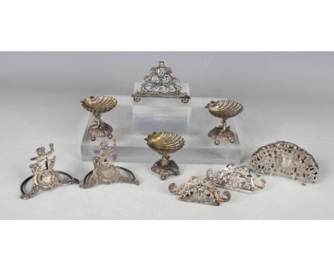 An Edwardian silver menu holder, cast with amorini and scrolls, on bun feet, Sheffield 1901 by William Hutton &amp; Sons Ltd,