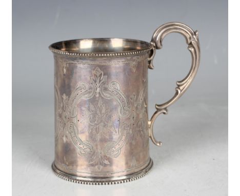 A Victorian silver christening tankard of cylindrical form, engraved with flowers and stylized strapwork decoration between b