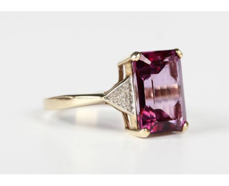 A 9ct gold ring, claw set with a rectangular pink/purple topaz topped doublet between diamond single stone shoulders, Birming