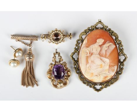 A Victorian gilt metal mounted oval shell cameo brooch, width 6.5cm, a Victorian gold and amethyst single stone pendant, moun