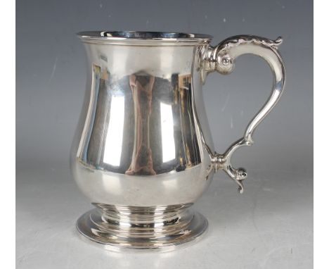 A Victorian silver baluster tankard with foliate capped scroll handle, on a circular domed foot, London 1875 by Richards &amp