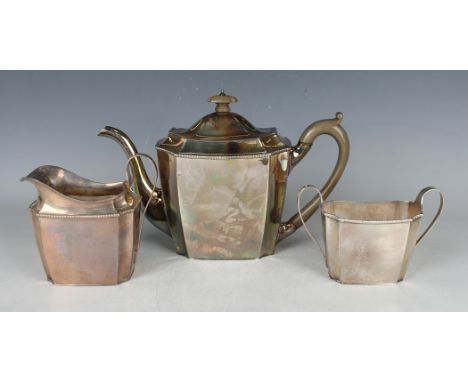 A George V silver three-piece tea set, each piece of canted corner rectangular form with reeded rims, comprising teapot, two-