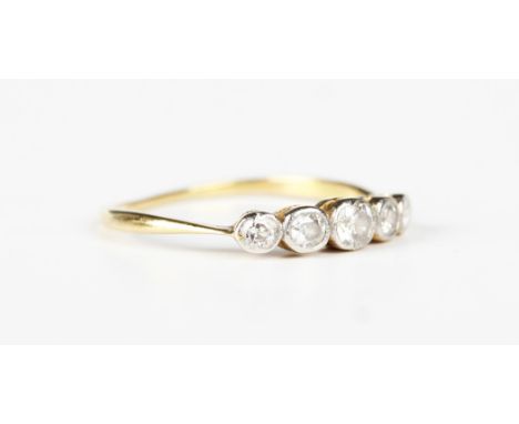 A gold and platinum diamond five stone ring, collet set with a row of cushion cut diamonds graduating in size to the centre s