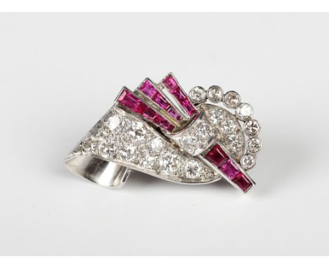 A diamond, ruby and red gem set single earclip, circa 1920, in a scrolled design, with post and sprung fitting, unmarked, len
