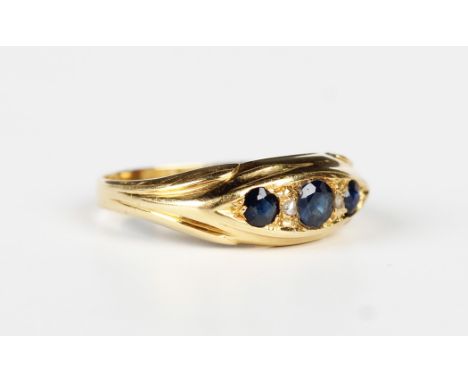 An 18ct gold, sapphire and diamond five stone ring, mounted with three sapphires and two diamonds in a boat shaped setting, C