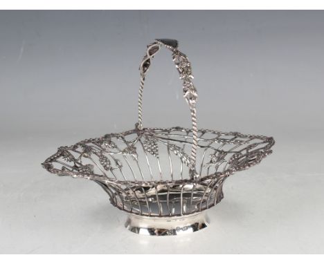 A late George II silver oval basket with foliate and spiral twisted swing handle above wirework sides, applied with a continu