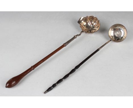 A George II silver punch ladle, the oval lobed bowl with pouring lip, fitted with a turned wood handle, London 1755 by Walter